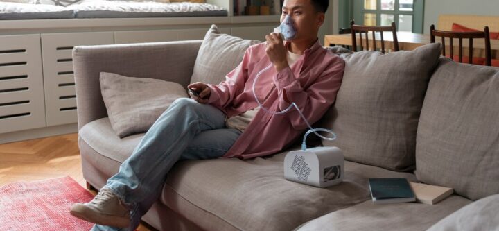 full-shot-man-using-nebulizer-home_23-2150562056